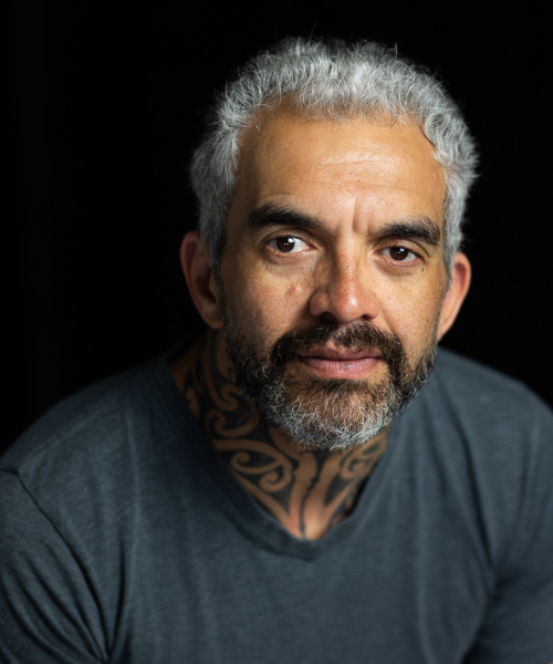 Emily poses for a headshot smiling at the camera.